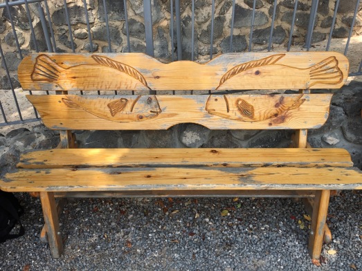 Bench with fishes engraved on it.